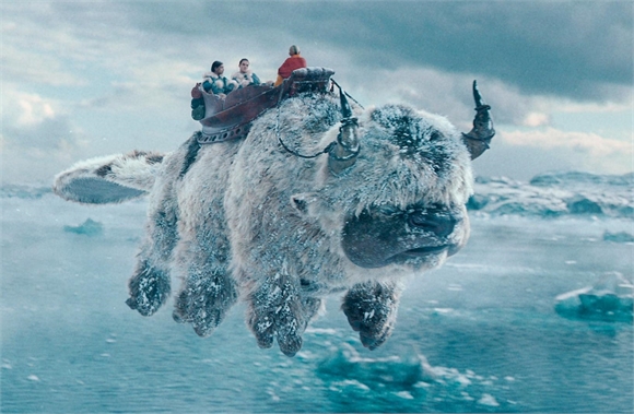 Three people sit in a saddle atop a massive, furry, horned creature flying over a frozen arctic landscape.