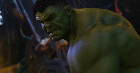 A muscular green-skinned humanoid with a furrowed brow and bared teeth looks intensely forward.