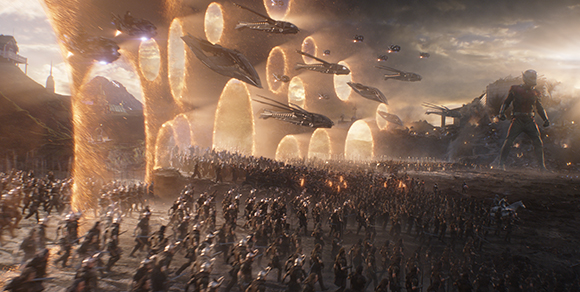 An army marches across a battlefield toward golden portals under a sky filled with large spacecraft.