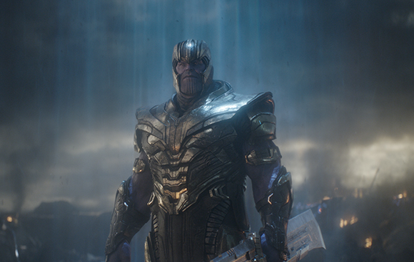 A large purple-skinned character wearing heavy gold armor stands against a dark, misty background.
