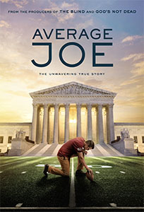 A man in a red shirt kneels on a football field to kick a ball in front of the Supreme Court building.