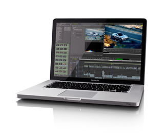 A silver laptop open on a white surface, displaying a video editing interface with a car clip.