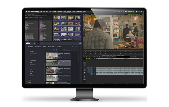 A desktop monitor showing a professional video editing interface with timelines, media bins, and a video preview.