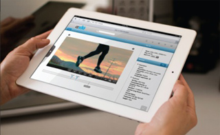 A person holds a white tablet showing a photo of a runner being edited in a software application.