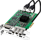 A green printed circuit board graphics card with a black heatsink and several connected black cables.