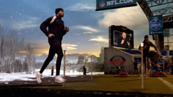 A man in black athletic gear runs through a snowy field toward an NFL-branded stadium setting.