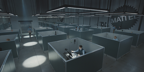 A wide shot of a modern office space featuring rows of grey cubicles and large rectangular light fixtures.