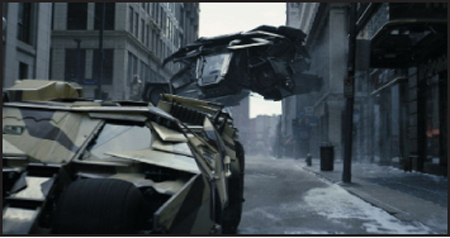 An armored, camouflage-patterned vehicle mid-air above a city street next to another armored vehicle.