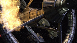 A massive metallic spacecraft undergoing a large explosion in deep space.
