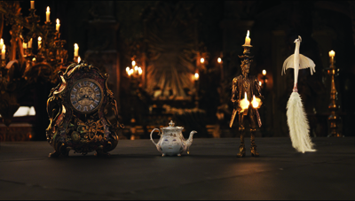 An ornate clock, a small teapot, a candle-headed figure, and a white bird figurine on a dark surface.