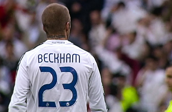 Back view of a soccer player in a white Real Madrid jersey with the name Beckham and number 23.
