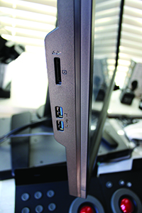 Close-up side view of a black computer monitor showing USB and audio ports.