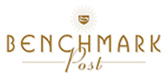 Gold text reading Benchmark Post with a sunburst emblem above it.