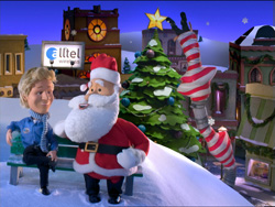 Santa Claus and a boy sit on a bench in a snowy, toy-like village with a decorated Christmas tree.