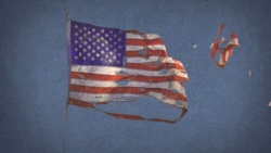 A worn and torn United States flag waving against a textured blue sky.