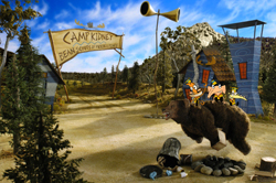 A cartoon bear stands in a clearing near a sign that reads 'Camp Kidney'.
