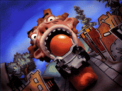 A large red cartoon monster head with wide eyes and an open mouth holding a large orange ball.
