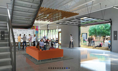 People lounge and work in a bright, modern open space with high ceilings and a large glass garage-style door.