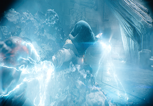 A hooded character releases bright blue electrical energy in a dark, cavernous stone setting.