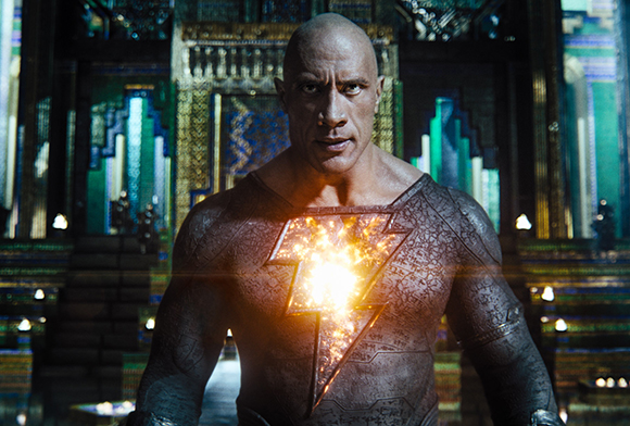 A muscular bald man in a textured suit with a glowing lightning bolt emblem on his chest.