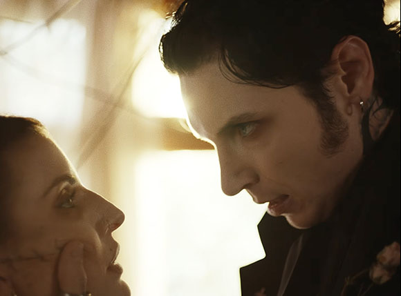 A man and a woman look intensely into each other's eyes in a close-up profile shot.