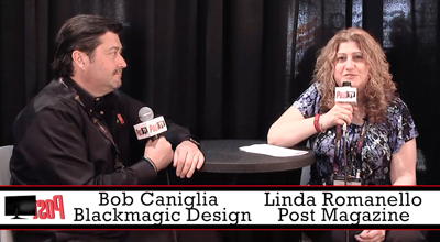 Bob Caniglia and Linda Romanello sit at a table with microphones during an interview.