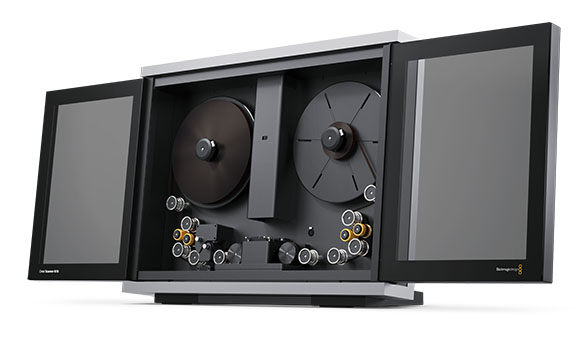 A professional reel-to-reel film projector with two large film reels and two open side monitor panels.