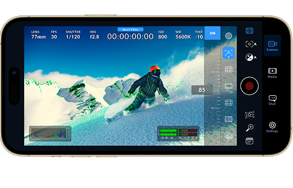 Smartphone screen showing a snowboarder on a mountain with professional camera settings overlays.