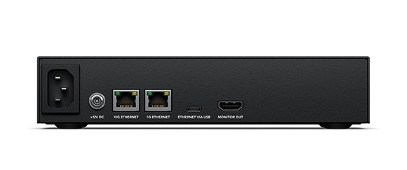 Rear view of a black electronic device with power, ethernet, USB, and HDMI ports.