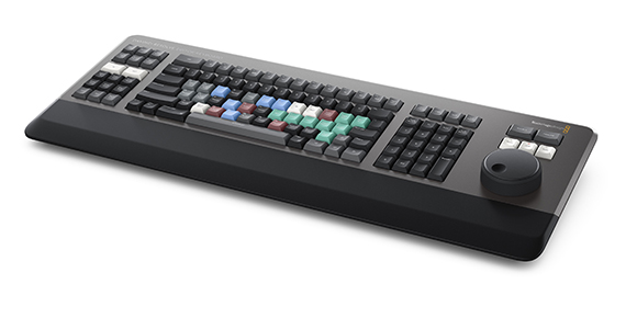 A black and grey control surface with multicolored buttons and a large circular dial on the right.