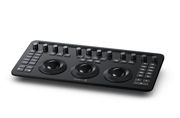 Black video editing control panel with various knobs, buttons, and three large trackball controllers.