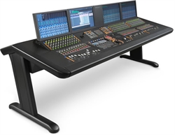 A professional audio mixing console with multiple screens displaying waveforms and numerous faders and knobs on a black desk.