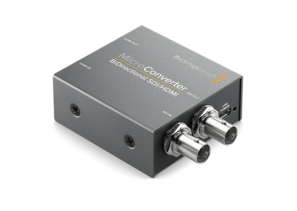 A small, grey rectangular Blackmagic Design Micro Converter with SDI and HDMI ports.