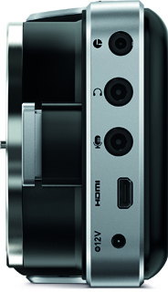 Side profile of a silver electronic device showing clock, headphone, microphone, HDMI, and 12V ports.
