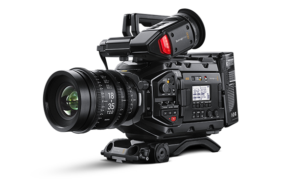 A professional black digital video camera with a large lens and various control buttons on a white background.