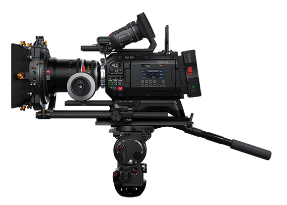 A professional black cinema camera equipped with a large lens, matte box, and monitor, mounted on a tripod head.