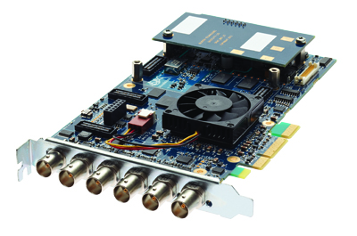 A blue printed circuit board with a black cooling fan and several silver circular video output ports.