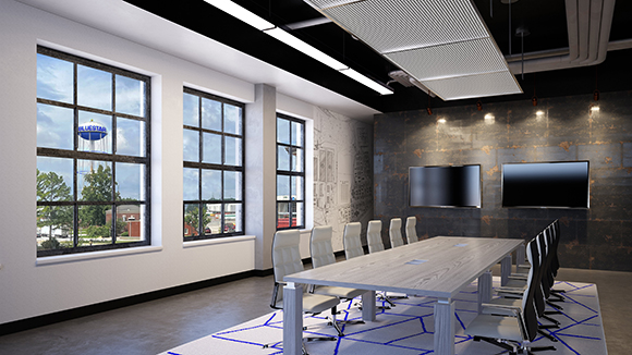 A modern conference room with a long wooden table, white chairs, and large windows overlooking trees.