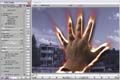 A computer screen showing photo editing software with a glowing, fiery hand superimposed over a city background.