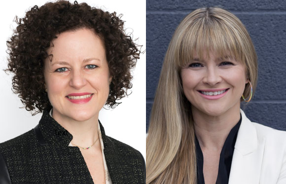 Two women smiling, one with dark curly hair and one with long blonde hair.