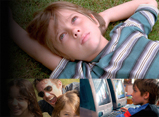 A young boy lies in the grass looking up at the sky, surrounded by smaller inset photos of people.
