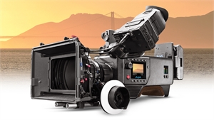 A professional cinema camera with a large lens and matte box set against a sunset mountain background.