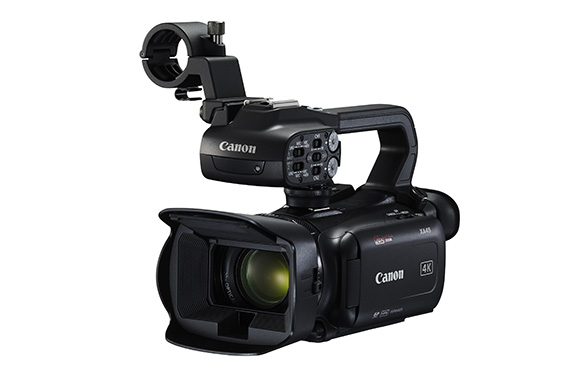 A black Canon professional 4K video camera with a large lens and a top handle mount.