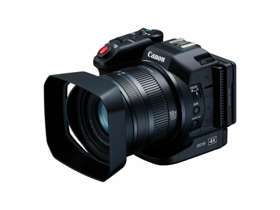 A black Canon XC10 4K camcorder with a large lens hood positioned on a white background.
