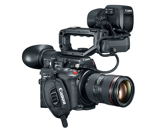 A black Canon professional video camera with a large lens, top handle, and external monitor.