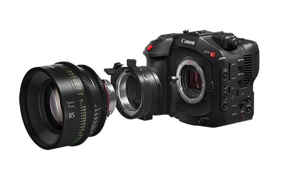 A black Canon EOS C cinema camera body next to a large professional cinema lens on a white background.