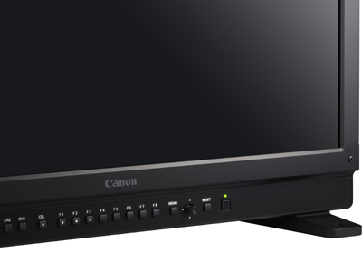 Close-up of the bottom edge of a black Canon monitor featuring various control buttons and the brand logo.