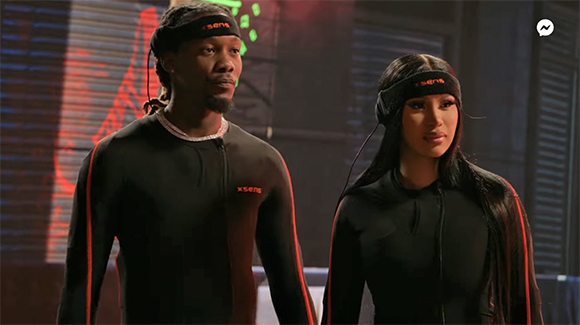 A man and a woman wearing black long-sleeved athletic shirts and black Xsens headbands.
