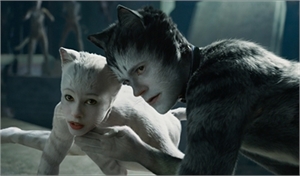Two people in cat-like makeup and fur costumes lean toward each other.