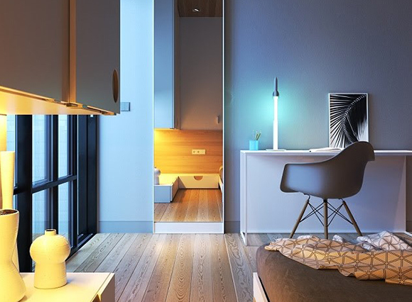 A modern bedroom featuring a white desk, a dark grey chair, and a large floor-to-ceiling mirror.